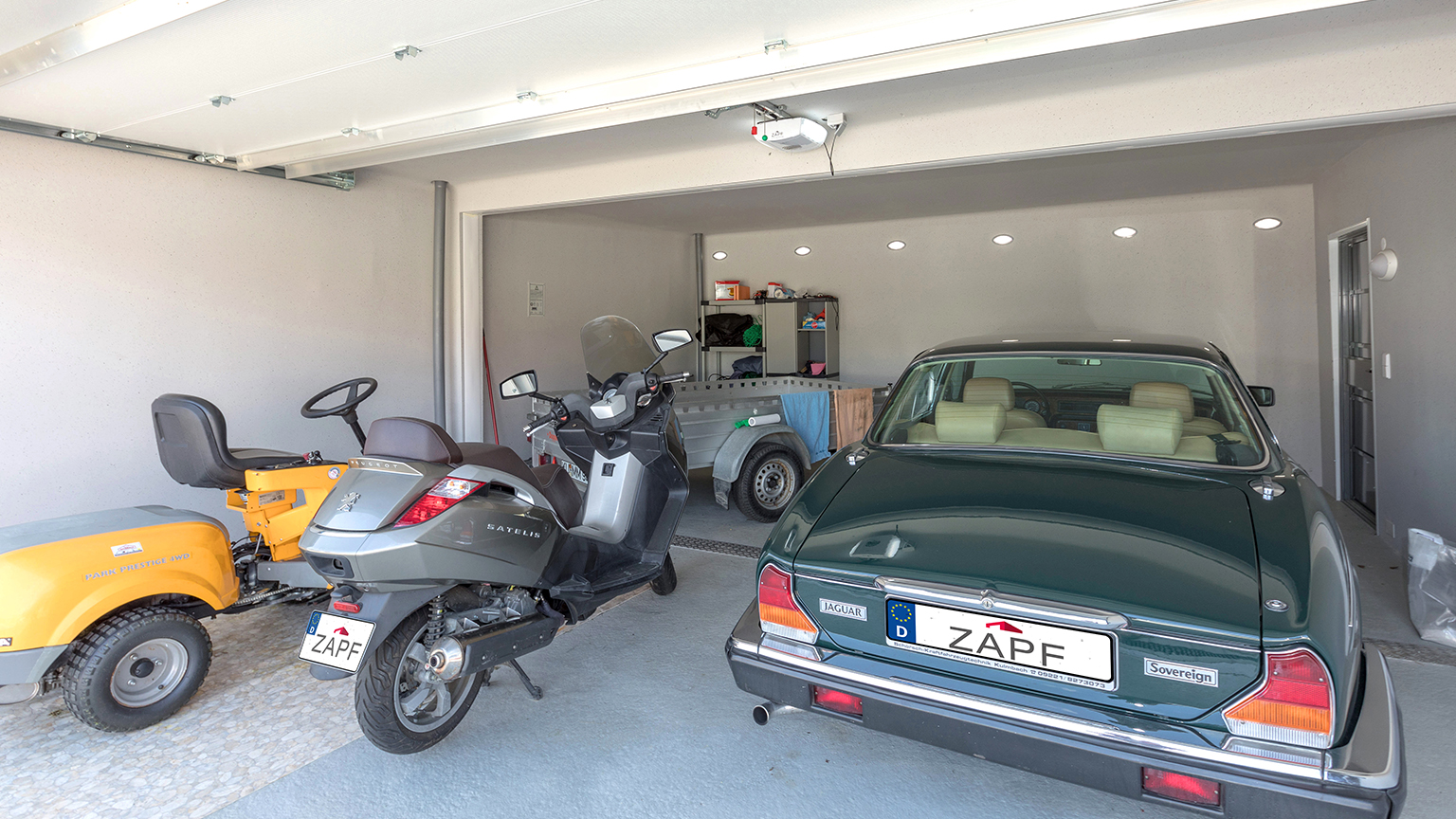 Innenansicht einer großzügigen Großraumgarage mit Oldtimer-Käfer und Regalwand – aufgeräumt und funktional gestaltet.