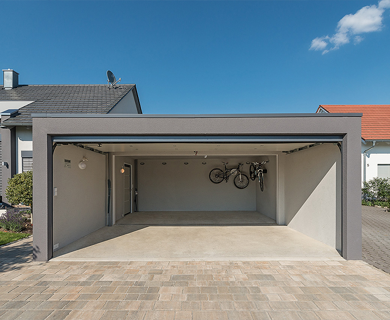 Open large garage with suspended bicycles and bright interior in the sunshine.