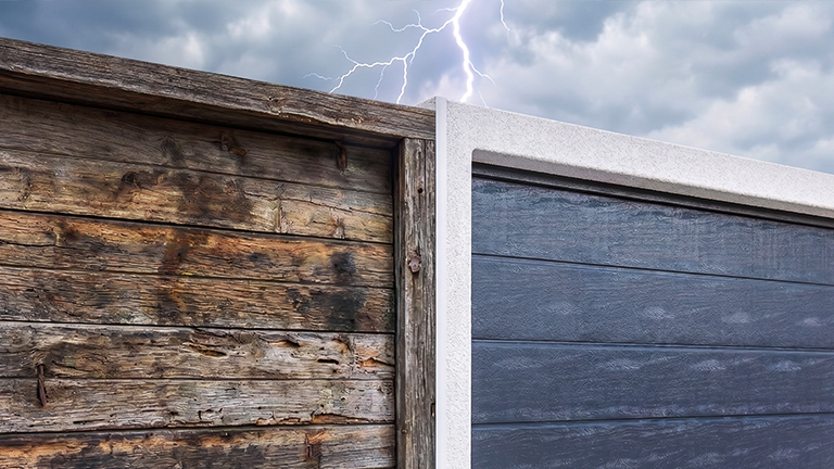 Weathered wooden garage door next to a modern precast concrete garage with a dark sectional door under a stormy sky with lightning by ZAPF
